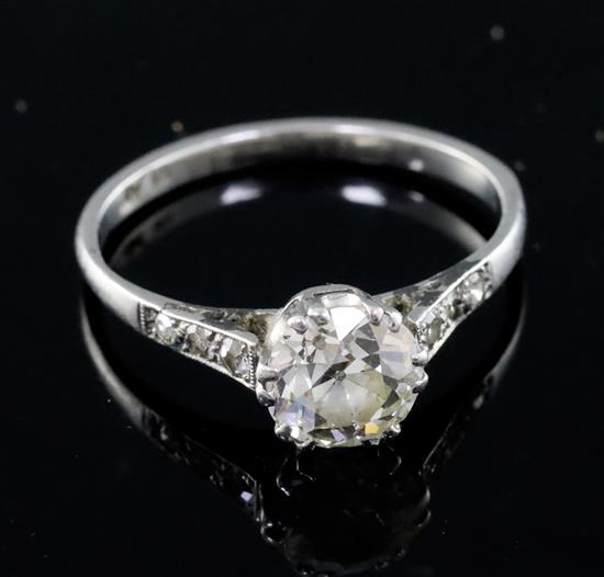 A mid 20th century platinum and single stone diamond ring, with diamond set shoulders, size P.
